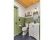 Bathroom featuring a toilet, sink, mirror, and wood plank ceiling at 400 Se 45Th Ter, Ocala, FL 34471