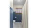 Bathroom showcases updated tiled flooring, modern blue wainscoting, and shower at 400 Se 45Th Ter, Ocala, FL 34471