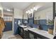 Bathroom featuring dual sinks, updated lighting, and contemporary blue paint at 400 Se 45Th Ter, Ocala, FL 34471