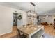 Bright dining room featuring a stylish light fixture and an adjacent doorway to kitchen at 400 Se 45Th Ter, Ocala, FL 34471