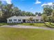 Charming single-story home boasts a well-manicured lawn and a circular driveway at 400 Se 45Th Ter, Ocala, FL 34471