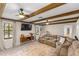 Living room featuring exposed beam ceiling, a comfortable couch and built-in shelving at 400 Se 45Th Ter, Ocala, FL 34471