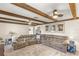 Spacious living room featuring a comfortable couch, exposed beam ceiling and decorative wall art at 400 Se 45Th Ter, Ocala, FL 34471