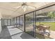 Spacious screened patio with an outdoor table set, hot tub, and a basketball court at 400 Se 45Th Ter, Ocala, FL 34471