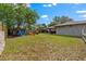 Large backyard features a playground, sandbox and mature trees, offering plenty of space for outdoor activities at 408 Etheredge St, Bushnell, FL 33513