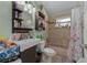 Well-appointed bathroom featuring a modern sink, decorative shelves, and a bathtub with shower at 408 Etheredge St, Bushnell, FL 33513