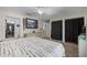 Bedroom with carpet floors, ceiling fan, floral wallpaper accent wall, and ensuite bathroom at 408 Etheredge St, Bushnell, FL 33513