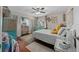 Comfortable bedroom with coastal decor, including a charming vanity and hardwood flooring at 408 Etheredge St, Bushnell, FL 33513