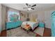 Bright bedroom with coastal style, featuring a vanity, matching nightstands, and unique wall decor at 408 Etheredge St, Bushnell, FL 33513