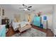 Cozy bedroom with a comfortable bed, colorful decor, and ample natural light at 408 Etheredge St, Bushnell, FL 33513