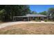 Charming single-story home featuring a covered carport and a well-maintained front yard at 408 Etheredge St, Bushnell, FL 33513