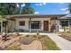 Charming single-story home with a covered front porch and well-maintained landscaping at 408 Etheredge St, Bushnell, FL 33513