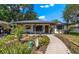 Charming single-story home with a well-manicured front yard and welcoming walkway to the front door at 408 Etheredge St, Bushnell, FL 33513