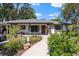 Inviting home featuring a walkway to the front door and lovely landscaping at 408 Etheredge St, Bushnell, FL 33513