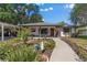 Charming single-story home with a well-manicured front yard and inviting walkway to the front door at 408 Etheredge St, Bushnell, FL 33513