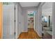 Hallway with hardwood floors connecting to bedrooms, creating a seamless flow throughout the home at 408 Etheredge St, Bushnell, FL 33513