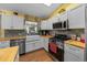 Bright kitchen with white cabinets, stainless steel appliances, and a farmhouse sink at 408 Etheredge St, Bushnell, FL 33513