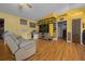 Cozy living room with neutral furniture, unique wall decor, and ceiling fan at 408 Etheredge St, Bushnell, FL 33513