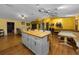 Large living room with dining area, wood floors, and a central island with seating at 408 Etheredge St, Bushnell, FL 33513