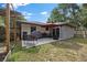 Relaxing patio with seating area, barbecue grill and outdoor umbrella, perfect for entertaining guests at 408 Etheredge St, Bushnell, FL 33513