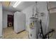 Utility room featuring tile floors, a water heater, and a secondary refrigerator at 408 Etheredge St, Bushnell, FL 33513