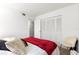 Comfortable bedroom features a cozy bed with plush linens, ample closet space, and neutral wall-to-wall carpeting at 450 Fairways Cir # A101, Ocala, FL 34472