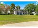 A two-story residential condominium building set on a green lawn, surrounded by mature trees at 450 Fairways Cir # A101, Ocala, FL 34472