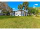Lush green lawn in front of a two-story condo building with palm trees at 450 Fairways Cir # A101, Ocala, FL 34472