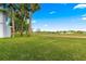 Expansive green space with towering palm trees, a beautiful clear sky, and lush lawns for outdoor enjoyment at 450 Fairways Cir # A101, Ocala, FL 34472