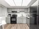 Well-lit kitchen with gray cabinets, modern appliances, and plenty of counter space at 450 Fairways Cir # A101, Ocala, FL 34472