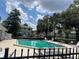 Community pool surrounded by lush trees and well-maintained landscaping offers residents a refreshing escape at 450 Fairways Cir # A101, Ocala, FL 34472