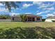Large backyard featuring lush green lawn and a pergola patio at 4735 Se 35Th St, Ocala, FL 34480