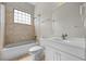 Bathroom featuring a shower-tub combo, vanity and tiled walls at 4735 Se 35Th St, Ocala, FL 34480
