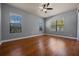 Large bedroom featuring hardwood floors, neutral walls, and natural light from big windows at 4735 Se 35Th St, Ocala, FL 34480