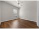 Bedroom with window, ceiling fan and wood floors at 4735 Se 35Th St, Ocala, FL 34480