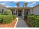 Inviting covered entryway with decorative columns and lush landscaping at 4735 Se 35Th St, Ocala, FL 34480
