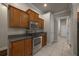 Well-equipped kitchen featuring stainless steel appliances, wooden cabinets, and tile flooring at 4735 Se 35Th St, Ocala, FL 34480