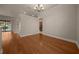 Open living area featuring hardwood flooring and views of the kitchen and lanai at 4735 Se 35Th St, Ocala, FL 34480