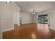 Open living room with hardwood floors, ceiling fan and sliding glass doors to the lanai at 4735 Se 35Th St, Ocala, FL 34480