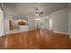 Open-concept living space with hardwood floors flowing into the kitchen area at 4735 Se 35Th St, Ocala, FL 34480