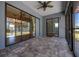 Screened in patio with brick pavers with ceiling fan with view into backyard at 4735 Se 35Th St, Ocala, FL 34480