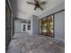 Spacious screened patio featuring a ceiling fan and brick pavers at 4735 Se 35Th St, Ocala, FL 34480