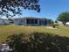 Well-maintained backyard featuring a screened-in lanai and a lovely lawn at 6239 Sw 98Th Loop, Ocala, FL 34476