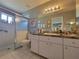 Bathroom featuring a glass-enclosed shower and a large vanity with plenty of counter space at 6239 Sw 98Th Loop, Ocala, FL 34476