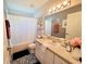 Stylish bathroom with decorative tile floor, vanity, and well-lit mirror at 6239 Sw 98Th Loop, Ocala, FL 34476