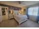 Comfortable bedroom featuring tile flooring, a ceiling fan, and a large window for natural light at 6239 Sw 98Th Loop, Ocala, FL 34476