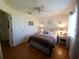 Bright bedroom with a queen bed, a ceiling fan, and natural light makes this space peaceful and relaxing at 6239 Sw 98Th Loop, Ocala, FL 34476