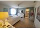 Bright bedroom featuring neutral decor, an ensuite bathroom, and ample natural light at 6239 Sw 98Th Loop, Ocala, FL 34476