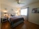 Well-lit bedroom with a comfortable queen-sized bed and a ceiling fan creates a relaxing retreat at 6239 Sw 98Th Loop, Ocala, FL 34476