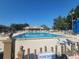 Large community swimming pool surrounded by lounge chairs and a covered pavilion at 6239 Sw 98Th Loop, Ocala, FL 34476